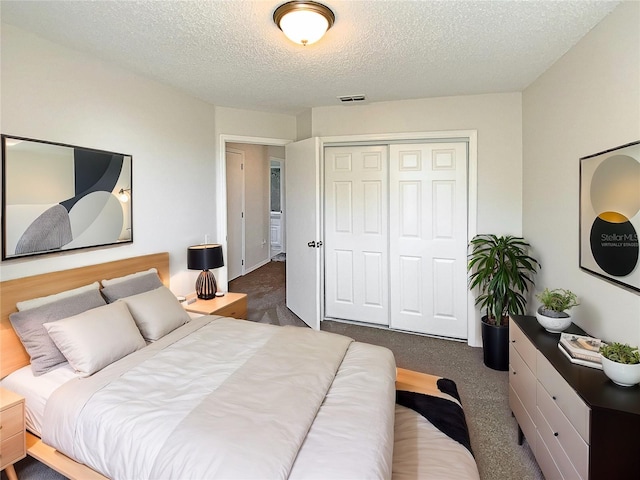 bedroom with dark carpet, a closet, and a textured ceiling