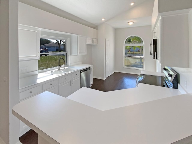 kitchen featuring white cabinetry, sink, lofted ceiling, and appliances with stainless steel finishes