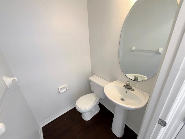 bathroom featuring sink, hardwood / wood-style floors, and toilet