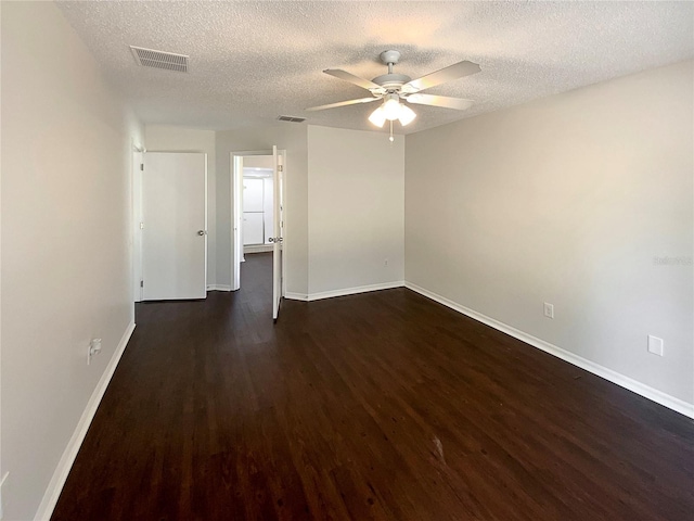 unfurnished room featuring ceiling fan, dark hardwood / wood-style flooring, and a textured ceiling