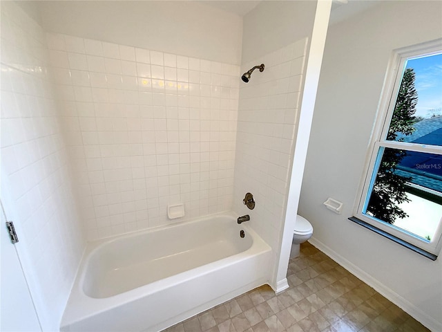 bathroom with tiled shower / bath and toilet