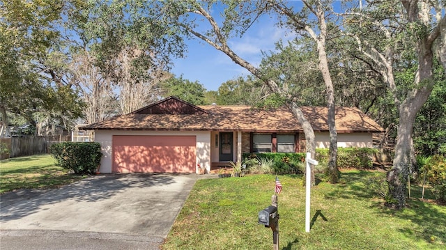 ranch-style home with a garage and a front yard