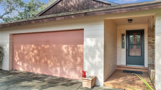 view of exterior entry with a garage