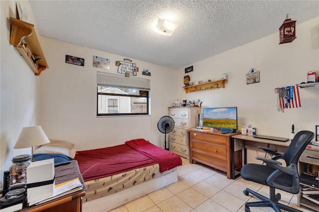 bedroom with light tile patterned floors and a textured ceiling