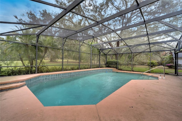 outdoor pool featuring glass enclosure and a patio