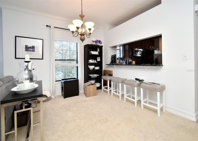 interior space with crown molding, light carpet, and an inviting chandelier