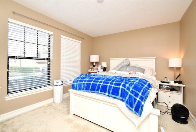 bedroom with carpet flooring and a textured ceiling