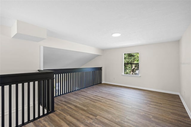 empty room featuring baseboards and wood finished floors