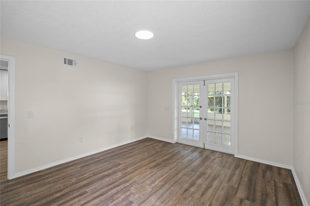 spare room with baseboards, visible vents, wood finished floors, and french doors