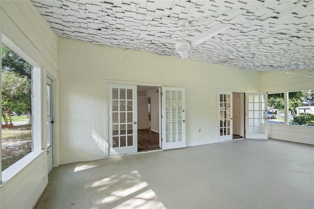 unfurnished sunroom featuring french doors