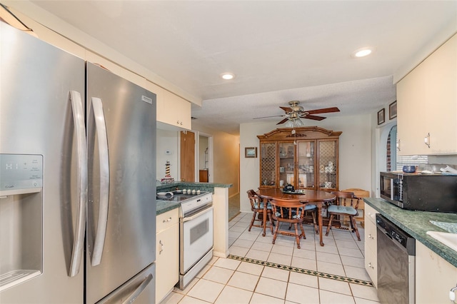 kitchen with light tile patterned floors, a ceiling fan, dark countertops, appliances with stainless steel finishes, and recessed lighting