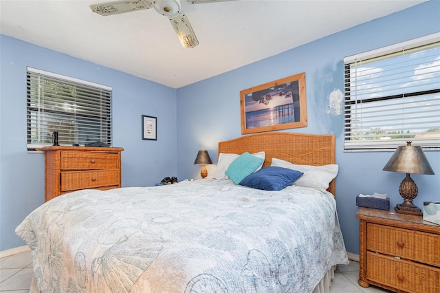 bedroom with multiple windows, baseboards, and light tile patterned flooring