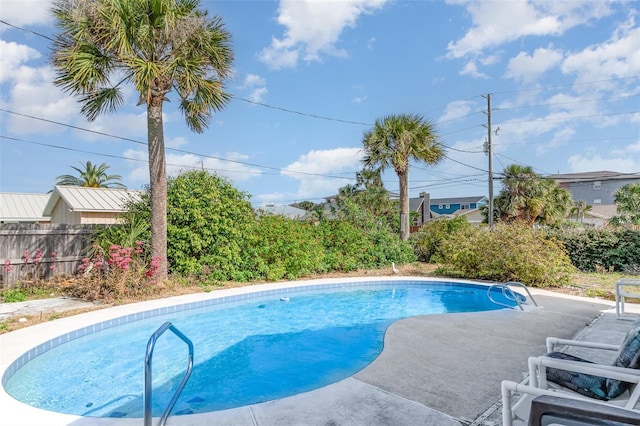 view of swimming pool with fence and a fenced in pool