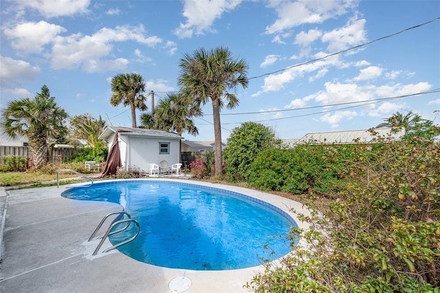 view of swimming pool featuring a fenced backyard, a fenced in pool, and an outbuilding