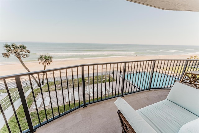 balcony with a view of the beach and a water view