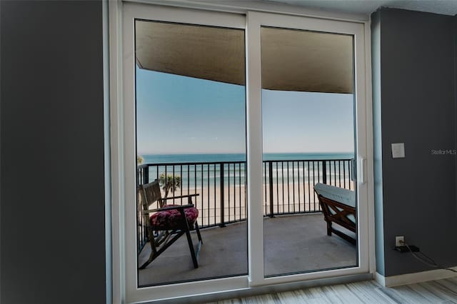 balcony with a water view and a beach view