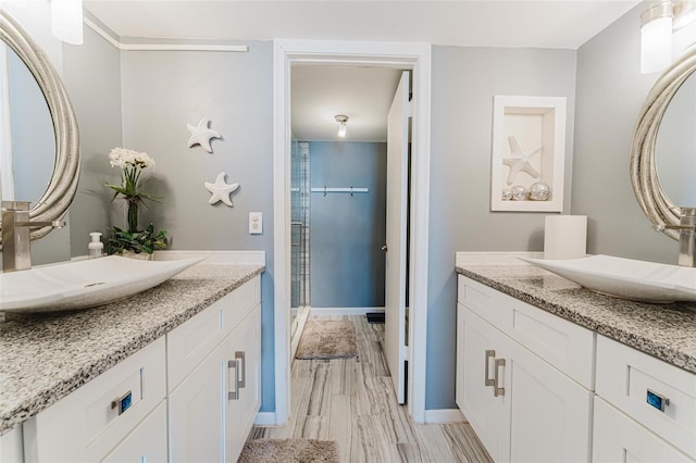 bathroom with vanity, an enclosed shower, and hardwood / wood-style flooring