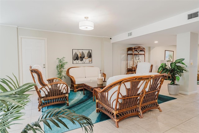 living area featuring ornamental molding and light tile patterned floors