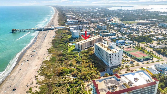 birds eye view of property with a view of the beach and a water view