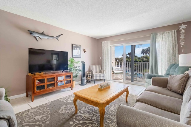 tiled living room featuring a textured ceiling