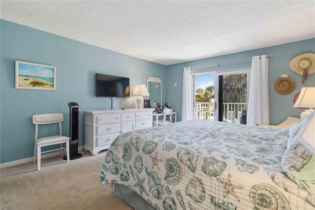 carpeted bedroom featuring access to exterior and a textured ceiling