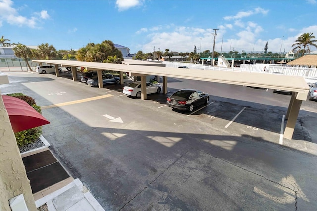 view of parking / parking lot featuring a carport