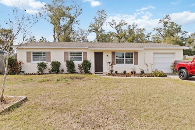 ranch-style house featuring a garage and a front lawn