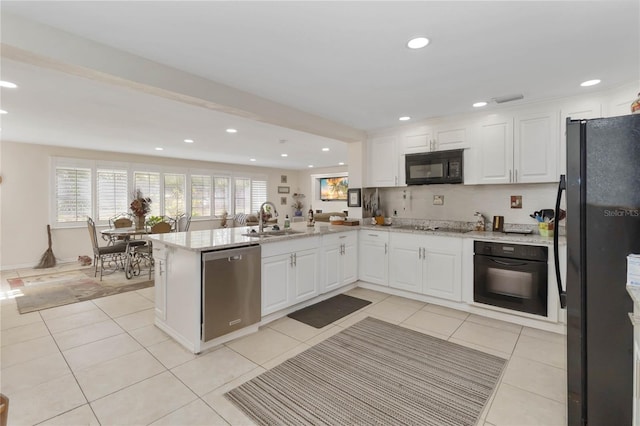 kitchen featuring white cabinets, kitchen peninsula, sink, and black appliances