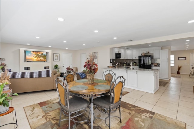 dining area with light tile patterned flooring and sink