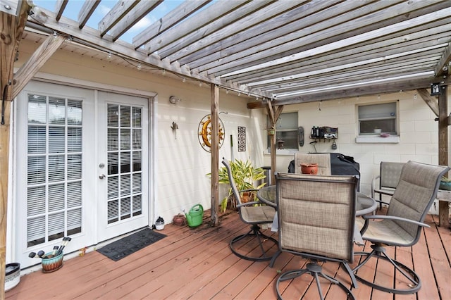 wooden terrace featuring french doors and a pergola