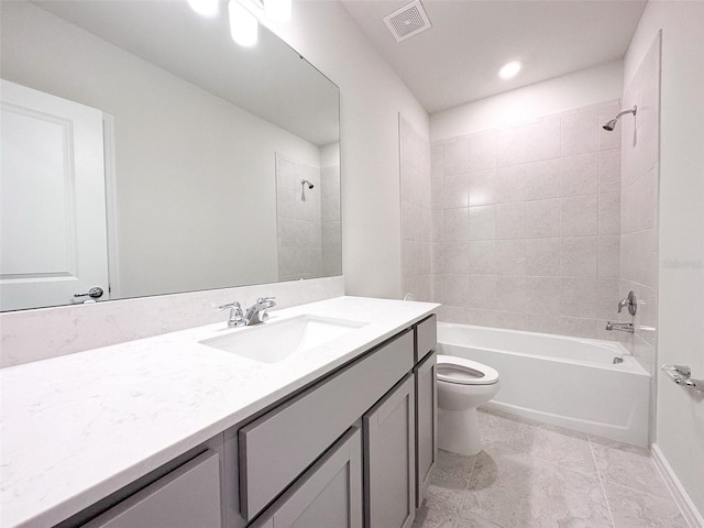 full bathroom featuring tiled shower / bath combo, vanity, and toilet