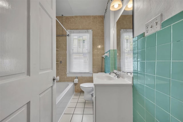 bathroom featuring a wealth of natural light, tile patterned flooring, tile walls, and vanity