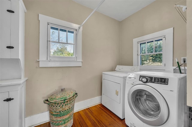 washroom with laundry area, independent washer and dryer, dark wood finished floors, and a wealth of natural light