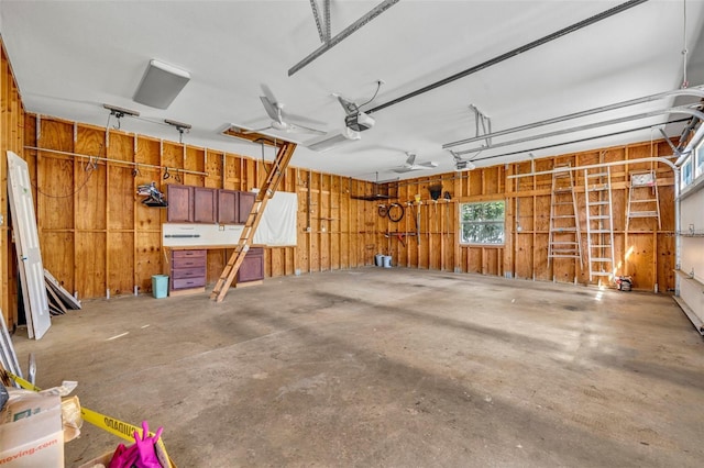 garage featuring a garage door opener and wood walls