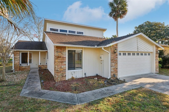124 Loon Ct, Daytona Beach, FL 32119 - view of front of property featuring stone siding, a garage, concrete driveway, and roof with shingles