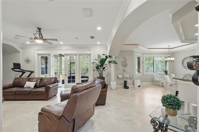 living room with baseboards, visible vents, ornamental molding, and french doors