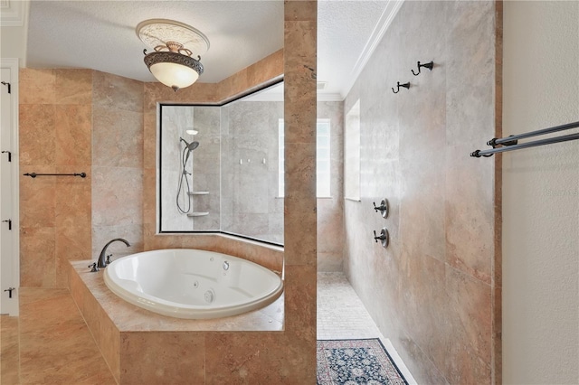 bathroom with crown molding, tile walls, a textured ceiling, a tub with jets, and walk in shower