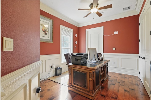 home office with crown molding, visible vents, a ceiling fan, and dark wood-type flooring