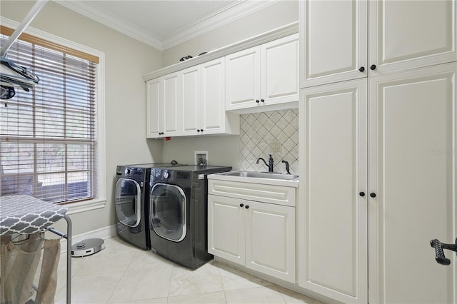 laundry area with light tile patterned floors, a sink, washer and dryer, ornamental molding, and cabinet space