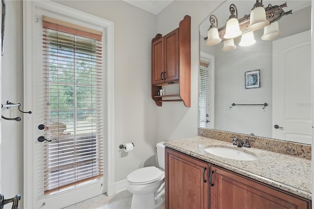 bathroom featuring toilet, tile patterned flooring, baseboards, and vanity