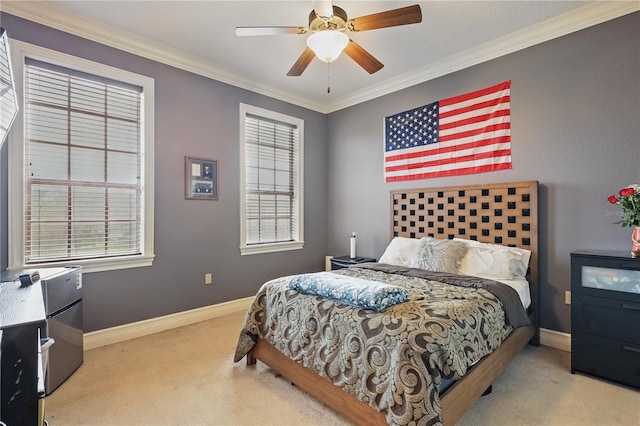 bedroom with a ceiling fan, light colored carpet, crown molding, and baseboards