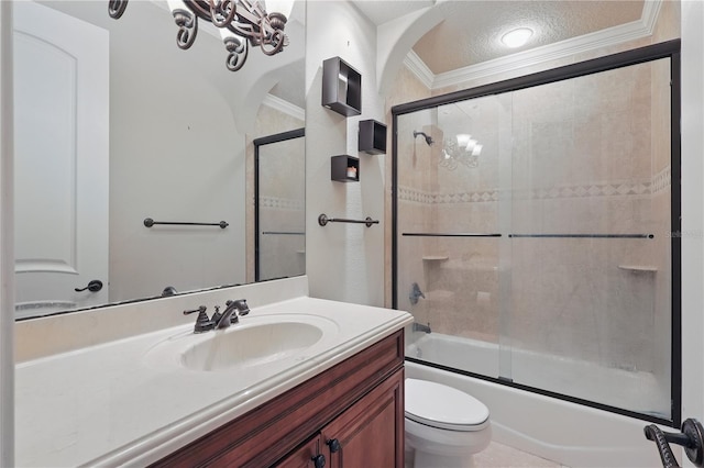 full bath with toilet, vanity, combined bath / shower with glass door, a textured ceiling, and crown molding