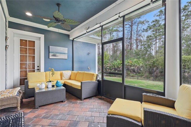 sunroom featuring ceiling fan