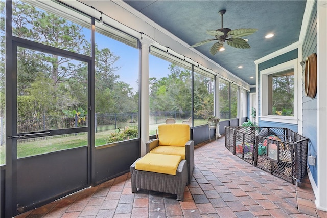 sunroom featuring ceiling fan