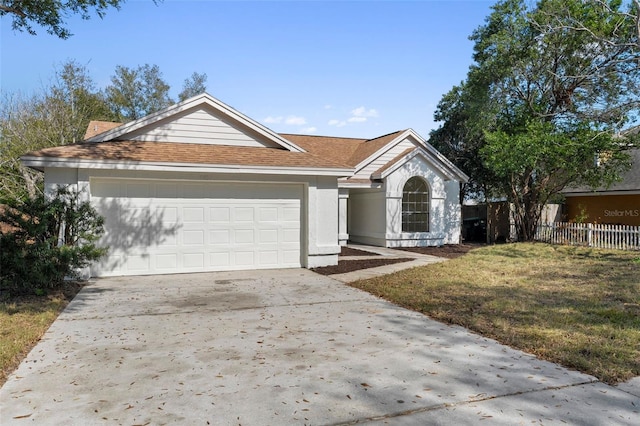 ranch-style house featuring a garage and a front yard