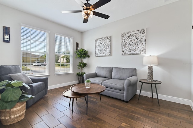 living room with ceiling fan and dark hardwood / wood-style flooring