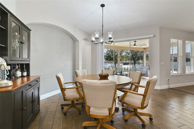 dining space with an inviting chandelier and dark hardwood / wood-style flooring