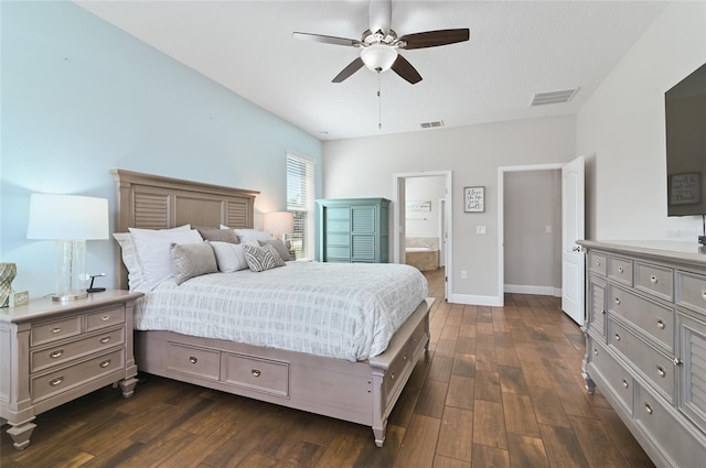 bedroom featuring ensuite bath, dark wood-type flooring, and ceiling fan