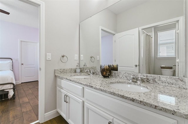 bathroom featuring vanity, ceiling fan, wood-type flooring, and toilet