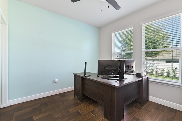 home office featuring dark wood-type flooring, ceiling fan, and plenty of natural light